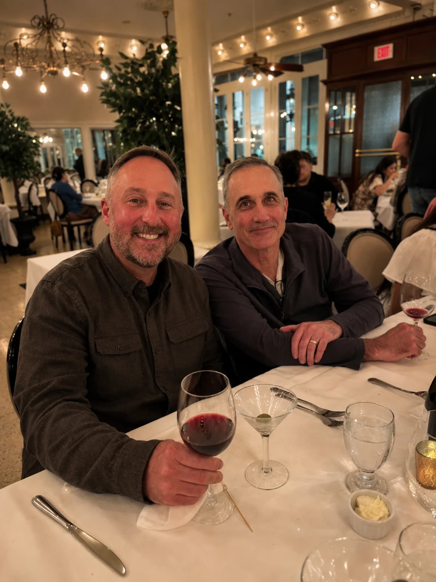 Two guests sharing conversation over dinner
